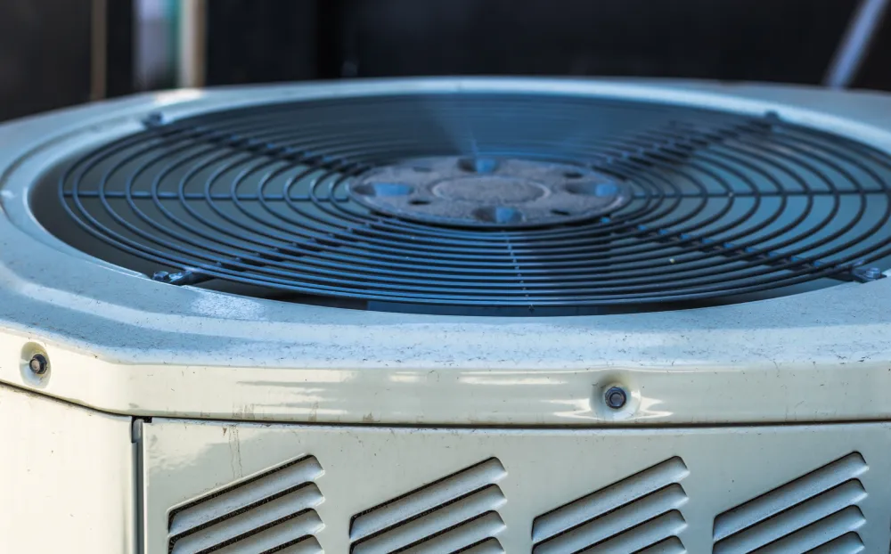 Perfect Timing Heating & Cooling performing AC maintenance on a residential air conditioning unit to improve cooling efficiency and system performance