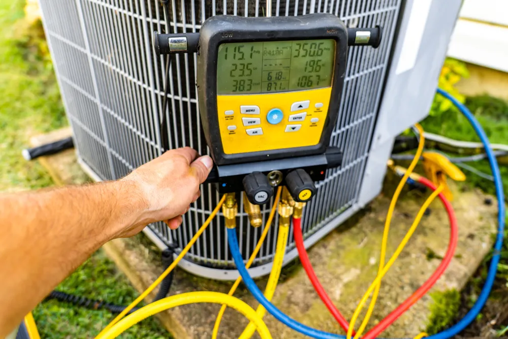 Perfect Timing Heating & Cooling technician performing AC repair and diagnostic testing on a residential air conditioning system to restore reliable cooling