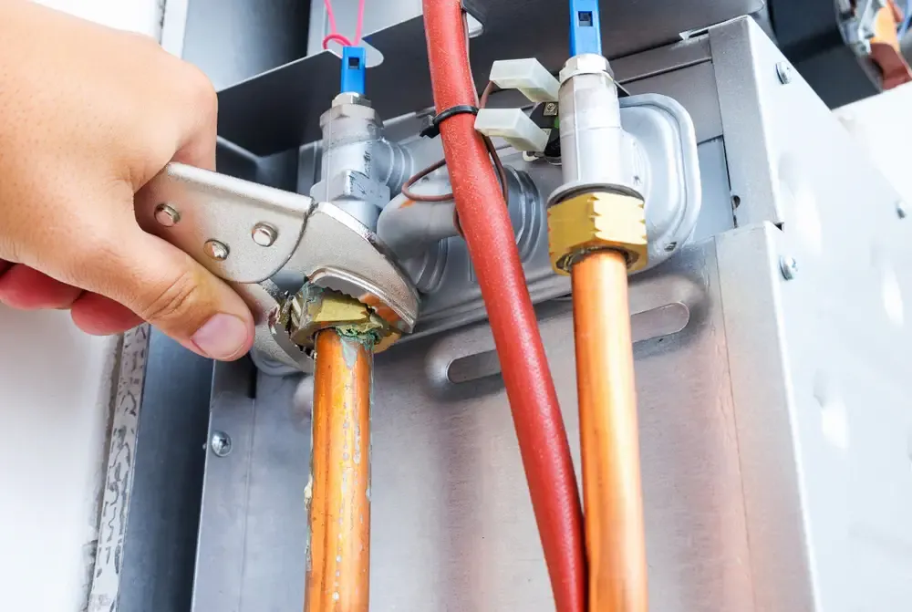 Perfect Timing Heating & Cooling technician performing boiler maintenance on a residential boiler system to improve efficiency, reliability, and long-term performance