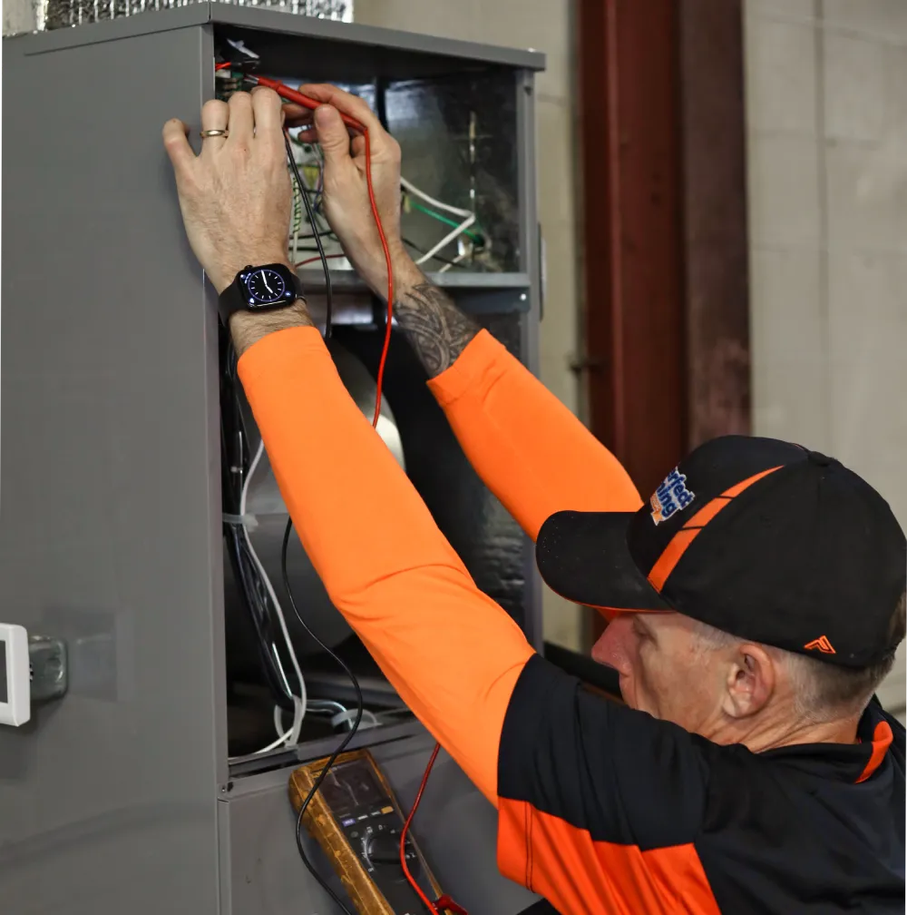 Perfect Timing Heating & Cooling technician performing furnace installation and system setup to ensure reliable home heating performance