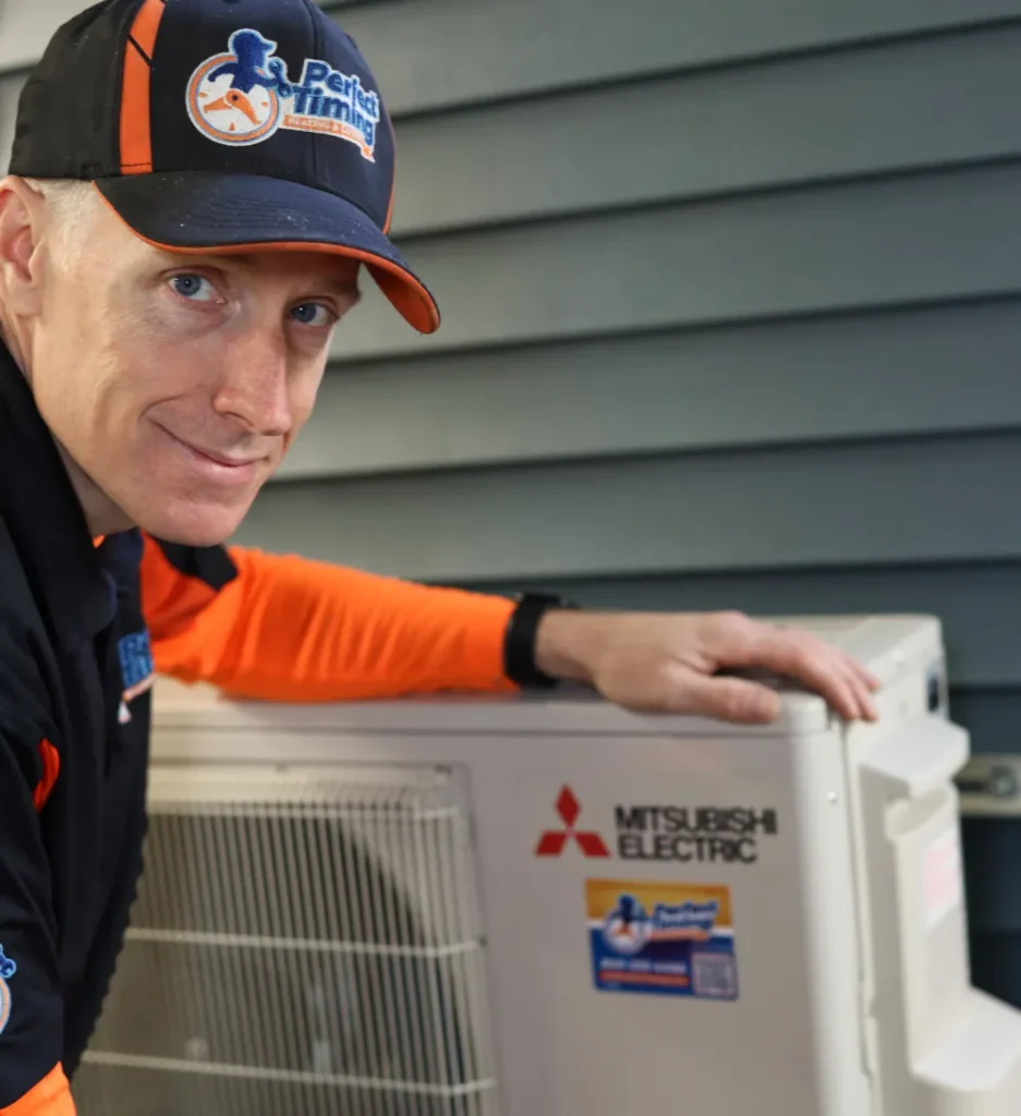 Perfect Timing Heating & Cooling technician completing a Mitsubishi Electric heat pump installation for efficient residential heating and cooling