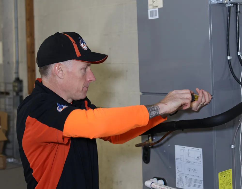 Perfect Timing Heating & Cooling technician completing a heating installation and system setup to provide efficient and dependable home heating