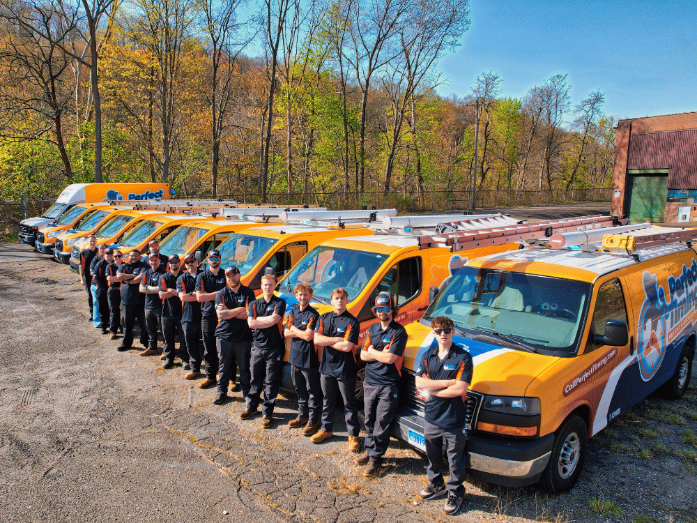 Perfect Timing Heating & Cooling team standing in front of their service vans, serving homeowners in West Simsbury, CT.